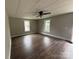 Bright living area featuring modern wood-look flooring, neutral walls, and a ceiling fan at 103 Meadow Ne Ave # 6, Concord, NC 28025