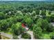An aerial view shows the home nestled among mature trees, accessible by a long driveway at 10379 Turnplow Dr, Davidson, NC 28036