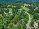 An aerial view shows the home nestled among mature trees, accessible by a long driveway at 10379 Turnplow Dr, Davidson, NC 28036