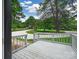 Spacious front deck overlooks the lush yard, perfect for relaxation and entertainment at 10379 Turnplow Dr, Davidson, NC 28036