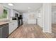 Open floorplan featuring a kitchen with white cabinets and stainless steel appliances at 10379 Turnplow Dr, Davidson, NC 28036