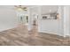 Open floor plan living room, kitchen, and dining area with hardwood floors and stainless steel appliances at 10379 Turnplow Dr, Davidson, NC 28036