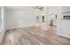 Open floor plan living room, kitchen, and dining area with hardwood floors and stainless steel appliances at 10379 Turnplow Dr, Davidson, NC 28036