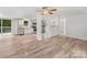 Open floor plan living room, kitchen, and dining area with hardwood floors and stainless steel appliances at 10379 Turnplow Dr, Davidson, NC 28036