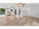 Open floor plan living room, kitchen, and dining area with hardwood floors and stainless steel appliances at 10379 Turnplow Dr, Davidson, NC 28036