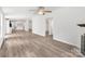 Open floor plan living room, kitchen, and dining area with hardwood floors and stainless steel appliances at 10379 Turnplow Dr, Davidson, NC 28036