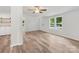 Open-concept living space features white walls, modern windows, and new wood-look flooring at 10379 Turnplow Dr, Davidson, NC 28036