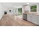 Open living space featuring updated kitchen and living areas with wood floors and windows at 10379 Turnplow Dr, Davidson, NC 28036