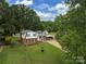 Aerial view of a charming home with a well and a spacious yard surrounded by lush greenery at 1040 Spring Dr, Gastonia, NC 28052