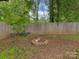 Backyard fire pit area with brick surround and ample space for seating, great for outdoor entertaining at 1040 Spring Dr, Gastonia, NC 28052