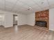 Finished basement with brick fireplace, vinyl floors, and open layout at 1040 Spring Dr, Gastonia, NC 28052