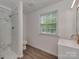 Bathroom featuring marble tile in shower, updated vanity and fixtures and vinyl flooring at 1040 Spring Dr, Gastonia, NC 28052