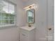 Bathroom vanity and window, showcasing modern fixtures, mirror, and natural light at 1040 Spring Dr, Gastonia, NC 28052