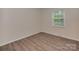 Well-lit bedroom with vinyl floors, neutral walls, window with blinds and a small vent at 1040 Spring Dr, Gastonia, NC 28052