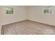 Bright bedroom with vinyl floors and two windows for plenty of natural light and ventilation at 1040 Spring Dr, Gastonia, NC 28052
