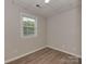 Bedroom with vinyl floors, neutral walls, window with blinds and a recessed light overhead at 1040 Spring Dr, Gastonia, NC 28052