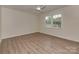 Bright bedroom with modern floors, a ceiling fan, and a large window offering an inviting space at 1040 Spring Dr, Gastonia, NC 28052
