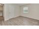 Bedroom with vinyl floors, single window and a closet for storage and organization at 1040 Spring Dr, Gastonia, NC 28052