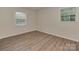 Cozy bedroom with vinyl floors and two windows letting in natural light for a bright space at 1040 Spring Dr, Gastonia, NC 28052