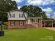 Charming two-story brick home with a well-maintained lawn and attached carport, perfect for suburban living at 1040 Spring Dr, Gastonia, NC 28052