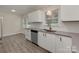 Bright kitchen features white cabinets, modern countertops, and stainless steel appliances, creating a fresh ambiance at 1040 Spring Dr, Gastonia, NC 28052