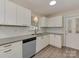 A modern kitchen is equipped with sleek countertops, white cabinets, and stainless steel appliances at 1040 Spring Dr, Gastonia, NC 28052