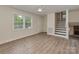 Bright living room features updated vinyl floors and natural light from the large window at 1040 Spring Dr, Gastonia, NC 28052