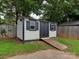 Outdoor shed with ramp for convenient access and storage, painted with black trim and decorative shutters at 1040 Spring Dr, Gastonia, NC 28052