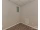 Unfinished room with vinyl floors, electrical panel, and gray walls at 1040 Spring Dr, Gastonia, NC 28052