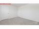 Neutral bedroom with two doors and carpeted floor provides a blank canvas at 11132 Cardinal Creek Ave, Charlotte, NC 28215