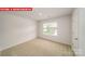 A bright bedroom is carpeted, offering a window with views and closet space at 11132 Cardinal Creek Ave, Charlotte, NC 28215
