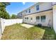 Townhome backyard with green grass, privacy fence, and small patio area at 12009 Elizabeth Madison Ct, Charlotte, NC 28277
