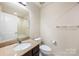 Bathroom with granite countertops, sink, and toilet next to walk-in shower at 12009 Elizabeth Madison Ct, Charlotte, NC 28277