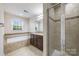 Luxurious bathroom with a soaking tub, walk-in shower, and granite vanity at 12009 Elizabeth Madison Ct, Charlotte, NC 28277