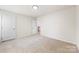 Bright bedroom with neutral carpet and a door to the hallway at 12009 Elizabeth Madison Ct, Charlotte, NC 28277