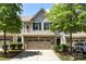 Charming townhouse with a two-car garage, brick accents, and manicured landscaping at 12009 Elizabeth Madison Ct, Charlotte, NC 28277