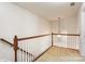 Second floor landing with wood railing and neutral carpet at 12009 Elizabeth Madison Ct, Charlotte, NC 28277