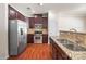 Bright kitchen featuring stainless steel appliances, granite countertops, and dark cabinetry at 12009 Elizabeth Madison Ct, Charlotte, NC 28277