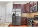 Modern kitchen with stainless steel appliances, dark wood cabinets, and granite countertops at 12009 Elizabeth Madison Ct, Charlotte, NC 28277