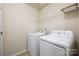 Functional laundry room with washer, dryer, and shelving for storage at 12009 Elizabeth Madison Ct, Charlotte, NC 28277