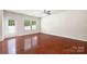 Spacious living room with hardwood floors, ceiling fan, a backyard door, and ample natural light at 12009 Elizabeth Madison Ct, Charlotte, NC 28277