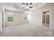 Spacious main bedroom featuring a ceiling fan, plush carpet and an en suite bathroom at 12009 Elizabeth Madison Ct, Charlotte, NC 28277