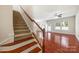 Inviting entryway featuring hardwood floors and carpeted staircase with wooden railing at 12009 Elizabeth Madison Ct, Charlotte, NC 28277