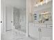 Bathroom with marble floors, a shower, and white cabinets at 13618 Tranquil Day Dr, Matthews, NC 28105