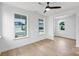 Light-filled bedroom with hardwood floors and large windows offering neighborhood views at 13618 Tranquil Day Dr, Matthews, NC 28105