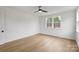 Bedroom with wood floors, white walls, recessed lighting, and large windows at 13618 Tranquil Day Dr, Matthews, NC 28105