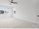 Large bedroom with carpet, multiple windows, and natural light at 13618 Tranquil Day Dr, Matthews, NC 28105