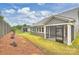 Home exterior displaying screened patio, siding, lawn, privacy fence, and professionally landscaped yard at 13618 Tranquil Day Dr, Matthews, NC 28105