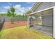 Exterior view of home, showcasing a screened-in patio and landscaped backyard with privacy fence at 13618 Tranquil Day Dr, Matthews, NC 28105