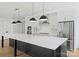 Bright kitchen with stainless appliances, white cabinets, and large black island with marble countertop at 13618 Tranquil Day Dr, Matthews, NC 28105